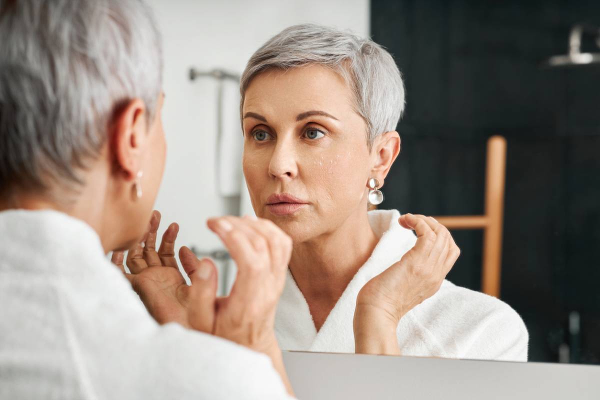 Woman checking for skin changes at her age