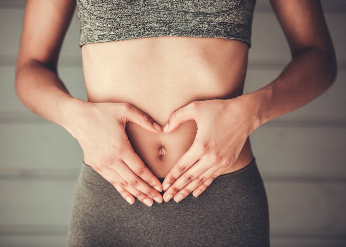 Woman with tight stomach and other unexpected tummy tuck benefits