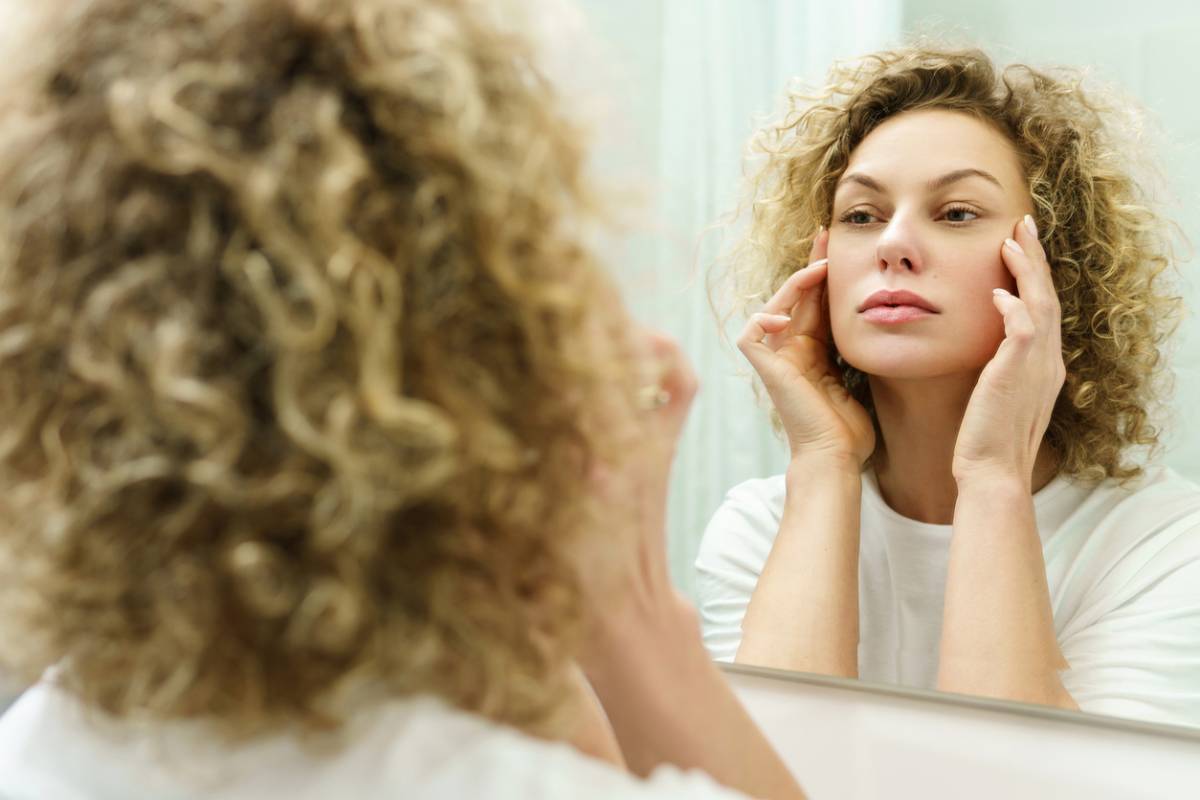 Woman checking for wrinkles to appear as she ages